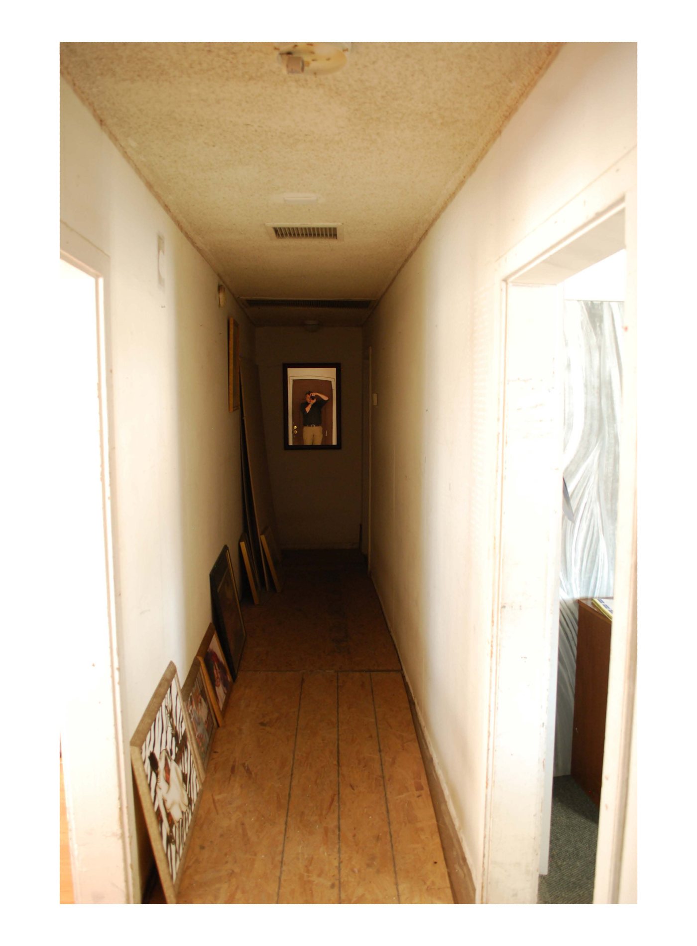 The main hallway inside Harrison's Guest House, looking west from the entrance, with bedroom doors opening off the corridor.